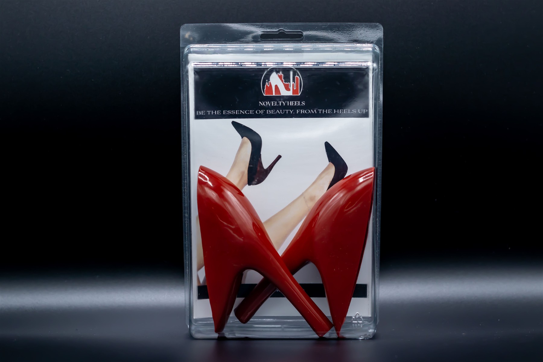 Novelty Heels retail package containing red slim high heel heel covers, shown without shoes