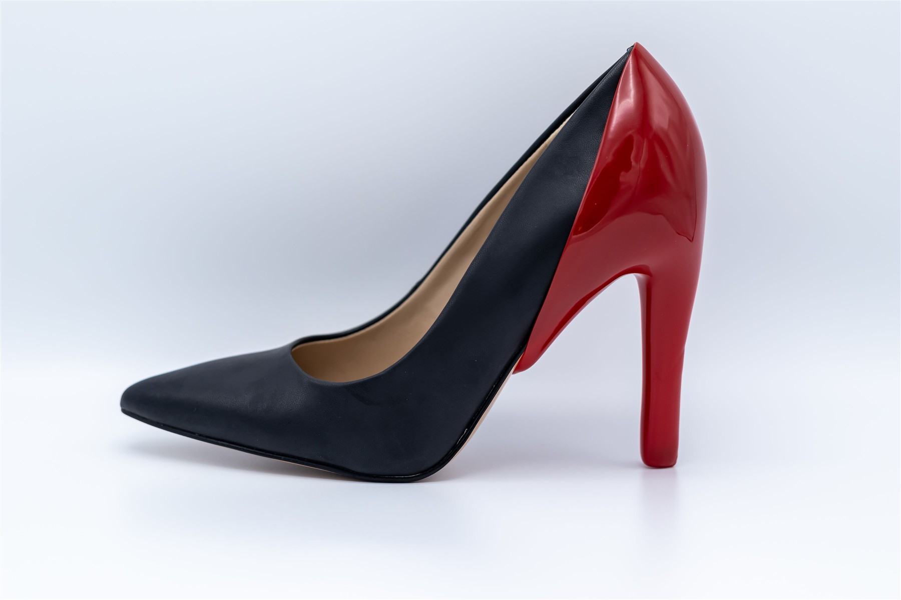 Red heel cover shown on a black slim high heel
