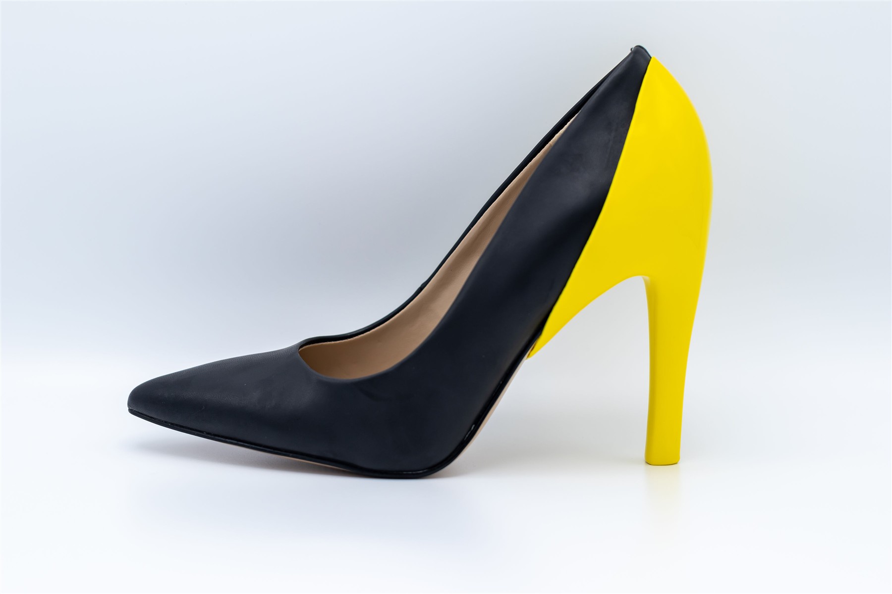 Yellow heel cover shown on a black slim high heel